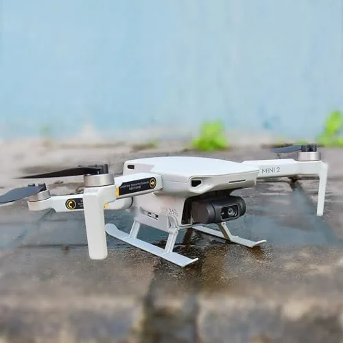 The drone taking off from a grassy field with the landing gear clearly visible