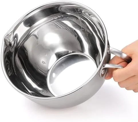 The double boiler set beside a microwave and a glass bowl over a saucepan