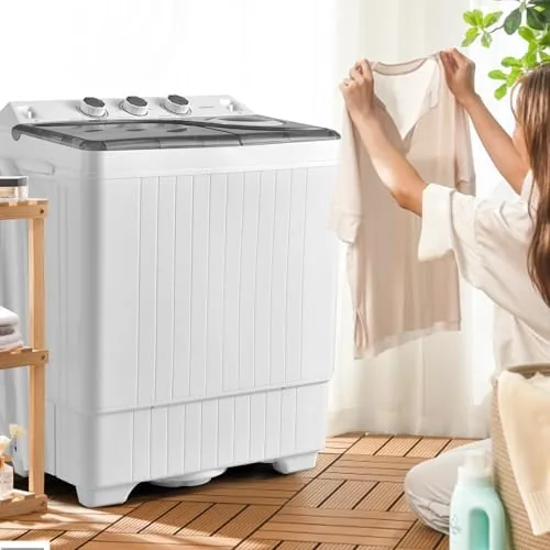 Clothes moving in the wash tub while the spinner sits beside it with its lid closed