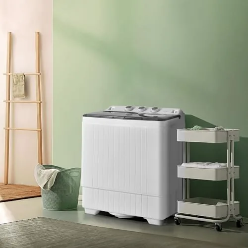 The machine draining sudsy water through its hose into a bathroom sink