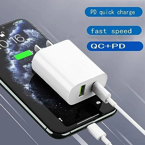 Charger cube plugged into a wall outlet next to a smartphone