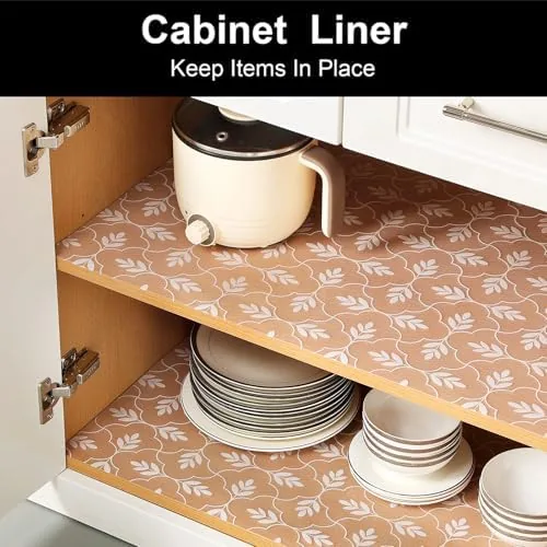 Shelf liner installed in a kitchen cabinet holding plates