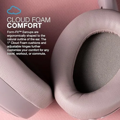 Woman wearing the Mauve JBuds Lux headphones on a flight