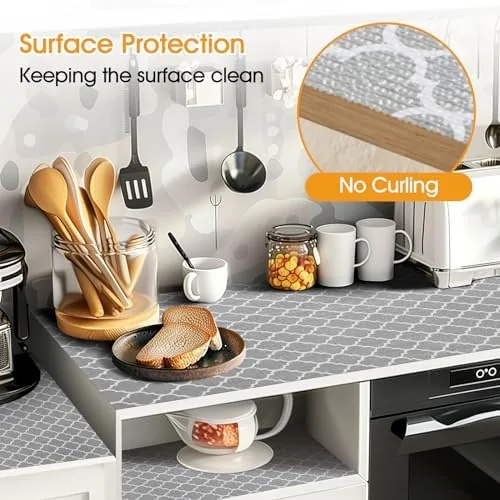 The liner installed in a kitchen cabinet with plates and jars on top