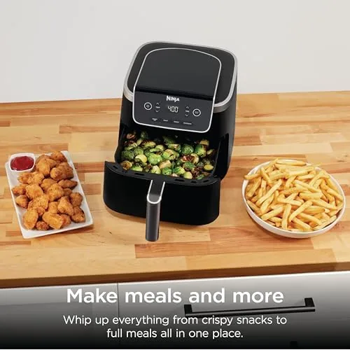 The AF141 basket next to a larger Ninja air fryer for scale