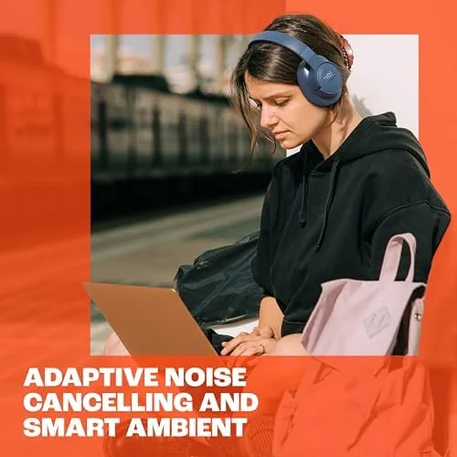 A person at a desk wearing the JBL Tune 770NC headphones