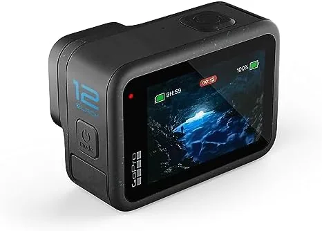 A surfer holding the HERO12 Black in its waterproof mount at the shore