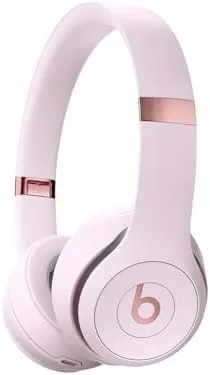 Beats Solo 4 headphones in Cloud Pink resting on a table