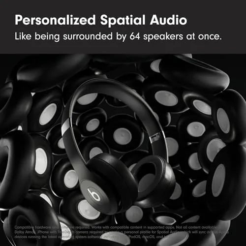 Beats Solo 4 Matte Black worn on a train with a window view