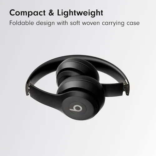 Beats Solo 4 Matte Black beside a notebook on a windowsill