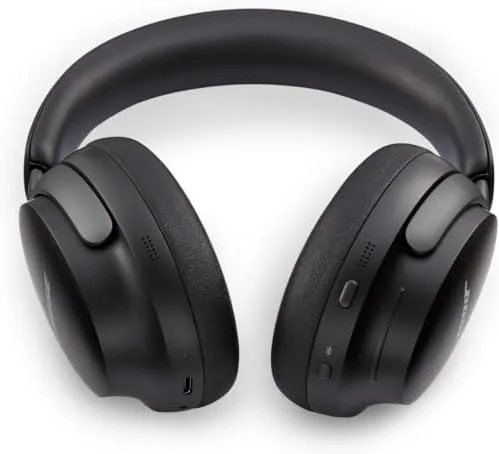 Bose QuietComfort Ultra black headphones beside a charging cable