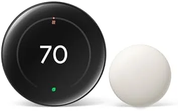 The Google Nest Learning Thermostat in Obsidian finish mounted on a hallway wall