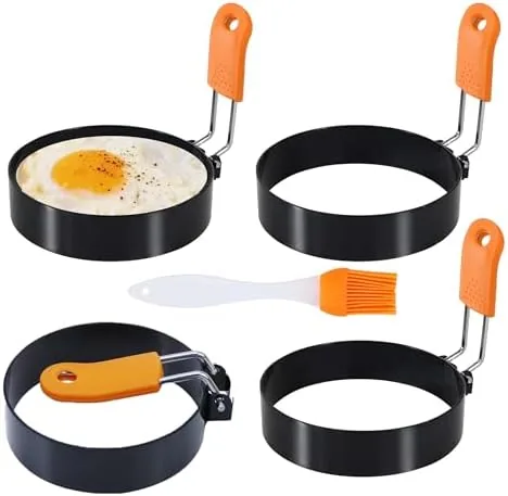 Four egg rings with silicone handles arranged with the included oil brush