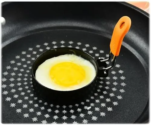 A perfectly round fried egg lifted from the ring onto a plate