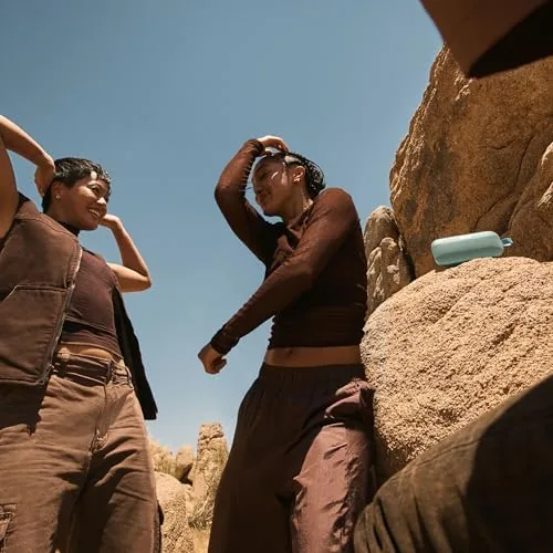 The speaker being rinsed with fresh water after exposure to sand