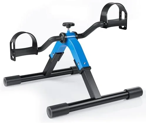 Folding pedal exerciser positioned under a desk with a chair in front