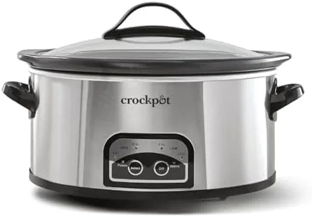 The stainless steel slow cooker on a kitchen counter with a full meal