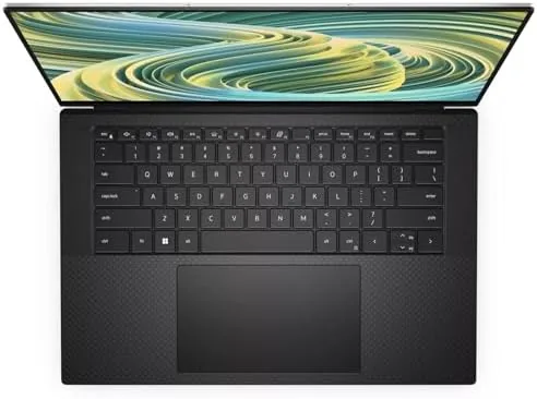 The XPS 15 9530 running multiple applications and a spreadsheet side by side