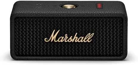 The Marshall Emberton III in its black and brass finish on a wooden table