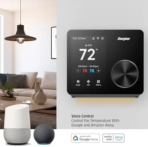 The thermostat glowing softly at night in a dark hallway