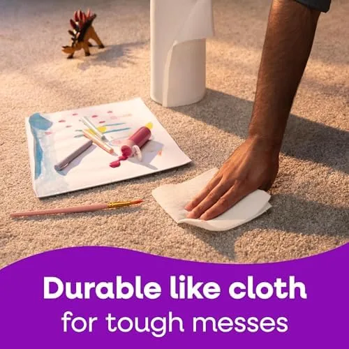 A sheet of Viva absorbing a puddle of water on a countertop