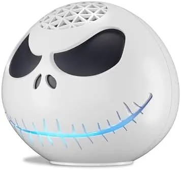The Jack Skellington Echo Dot on a desk with a lamp and books