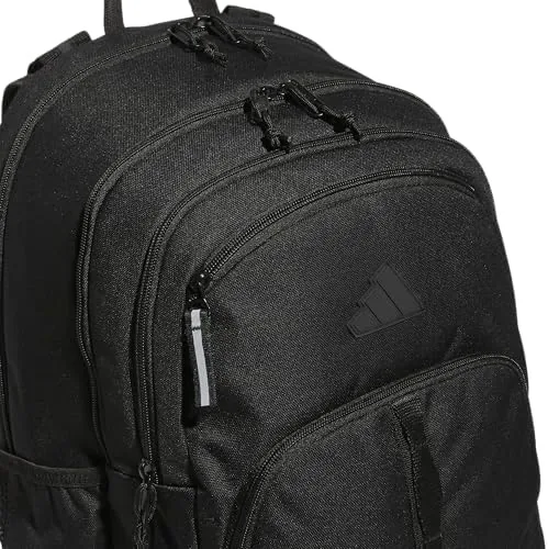 The adidas backpack stacked on a rolling suitcase in a station