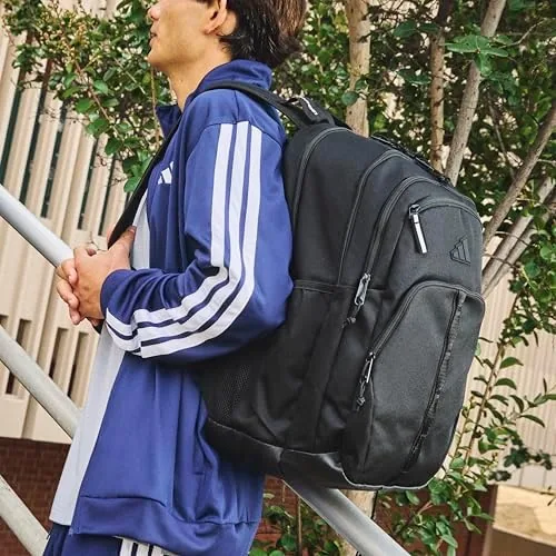 Student wearing the adidas Prime School Backpack on a walk to campus
