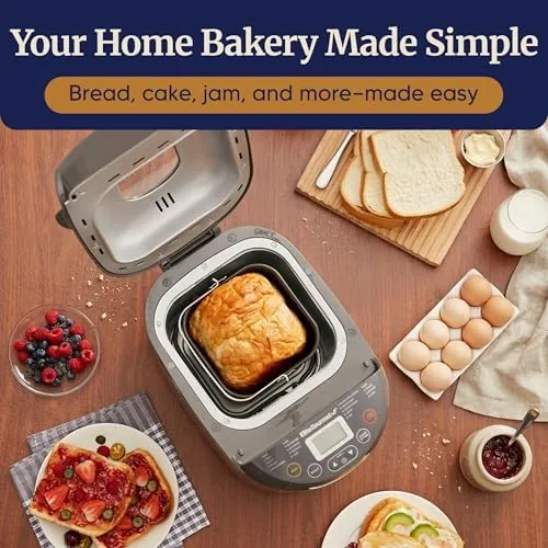 The bread maker on a counter with a sliced loaf and the measuring cup and spoon beside it