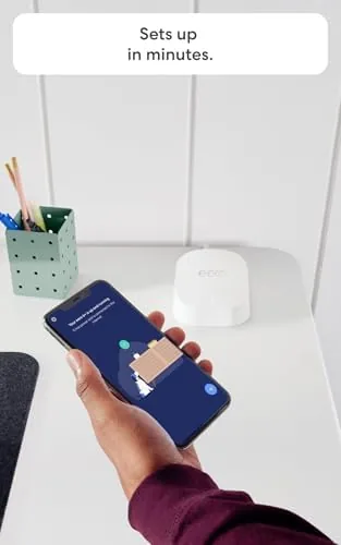 The eero 6+ node placed on a bookshelf in a living room