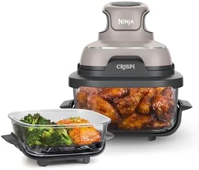 The Ninja Crispi glass air fryer with the clear glass cooking chamber on the counter
