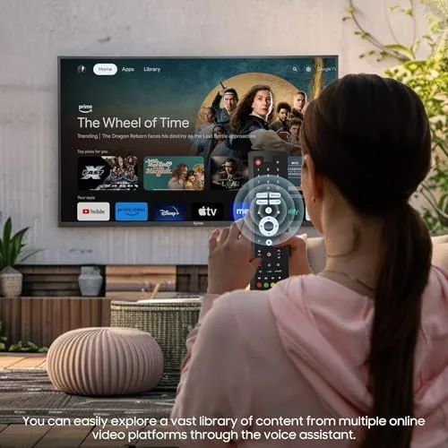 Family watching the outdoor TV on a covered patio in the evening