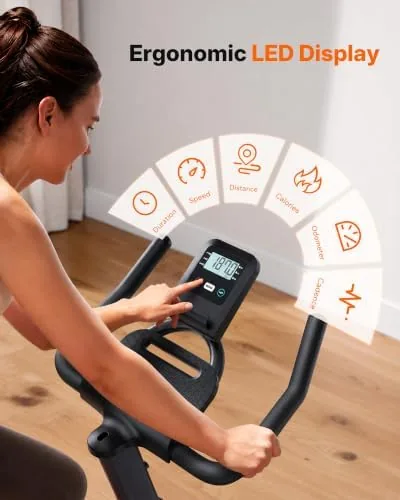 Merach bike beside a manual resistance exercise bike