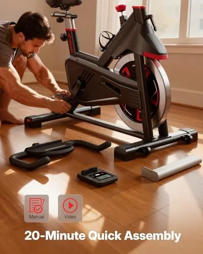 Home gym corner set up with the Merach bike, weights, and a mat