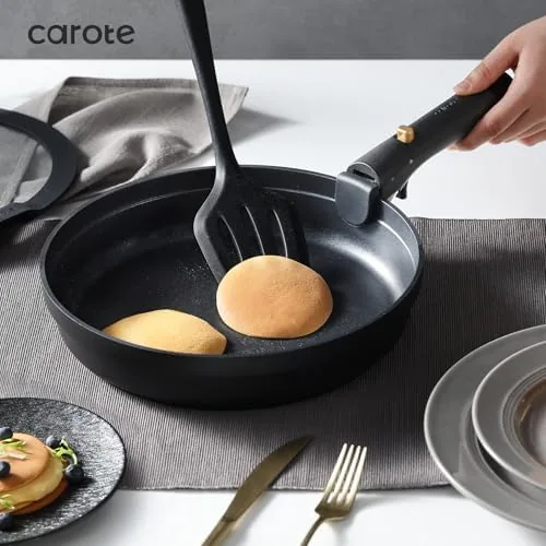 The pots and pans nested inside each other with handles removed and lids stacked