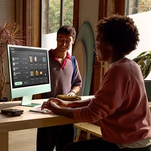 The iMac next to a Mac mini and a separate monitor for comparison