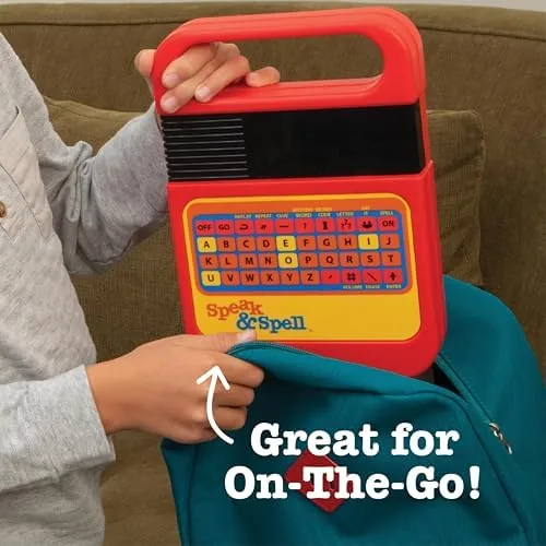 The Speak & Spell with batteries being placed in the back compartment