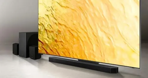 Subwoofer and rear speaker positioned in the corners of a living room