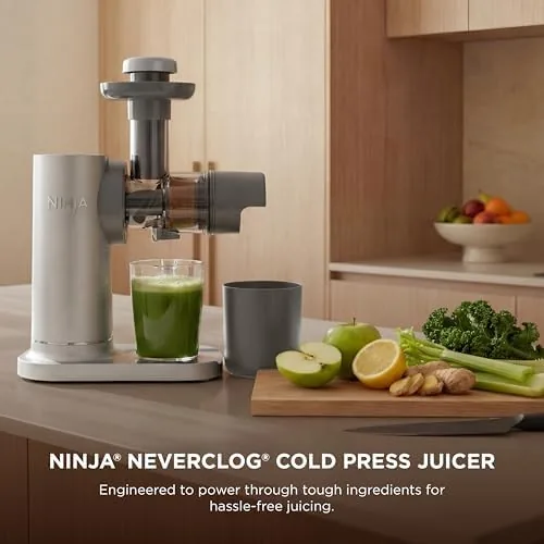 The auger and feed chute of the juicer removed for cleaning