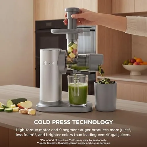 Celery and kale being fed into the chute of the NeverClog juicer