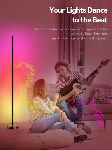 A living room at night lit only by the lamp with a slow color gradient up the column