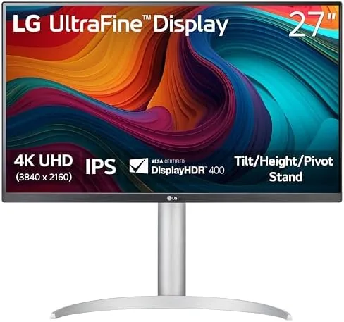 The LG 27UP650K-W white monitor on a desk with documents open
