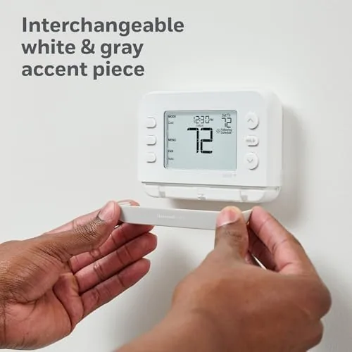 The thermostat in a hallway next to the door