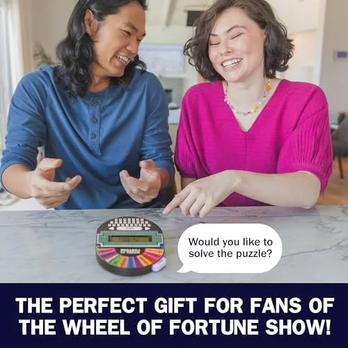 The Wheel of Fortune handheld game next to a smartphone and a board game