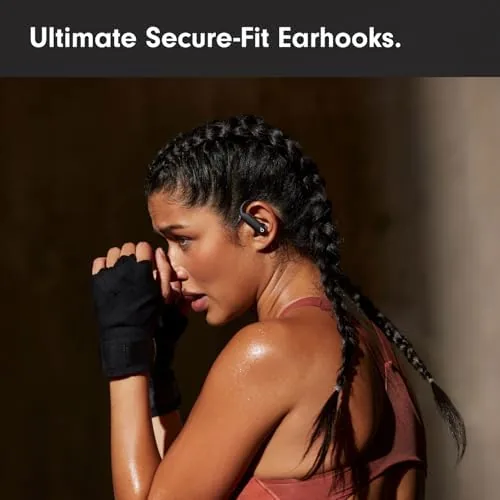 Earbuds in use during an outdoor run with traffic in the background