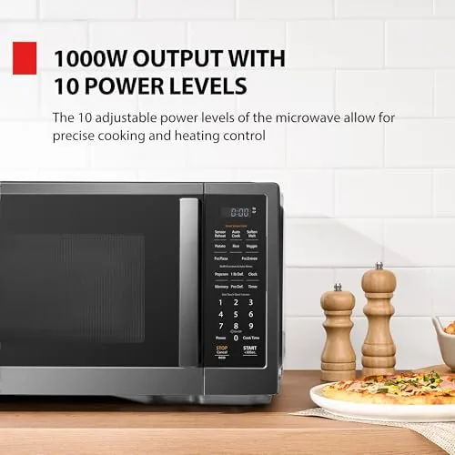 The microwave in a small apartment kitchen with the door open