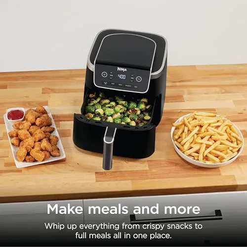 Crispy golden french fries and breaded chicken pieces in the air fryer basket