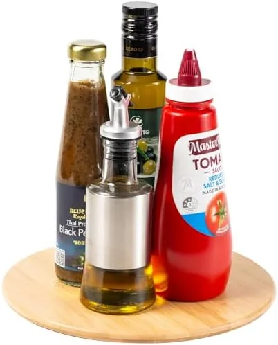 The 10-inch bamboo lazy susan sitting on a kitchen countertop with spice jars