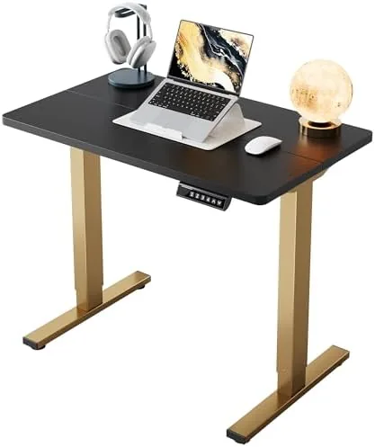 The HUANUO 32 inch electric standing desk in black with gold accents set up in a small office