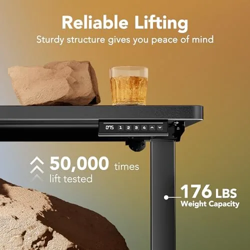 The desk raised to standing height with a monitor and laptop on top